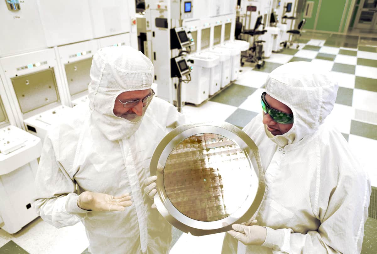 Scientists from SUNY Poly's Colleges of Nanoscale Science and Engineering and IBM Research inspect a wafer comprised of 7nm node test chips in a clean room in Albany, NY, in 2015.